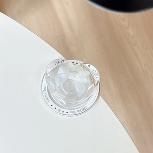 Close-up of heart-shaped Magsafe grip with glitter bow and Gift For You text