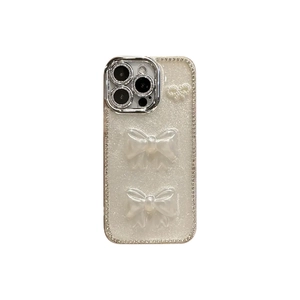 Coque iPhone de luxe avec nœuds 3D, texture pailletée perlée et cadre argenté galvanisé