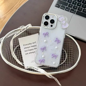 Detailed shot of transparent glitter iPhone case with purple bows and pearls in a basket