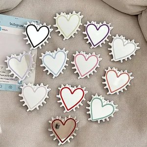 Minimalist heart-shaped phone grip stand with mirror finish in eleven assorted colors