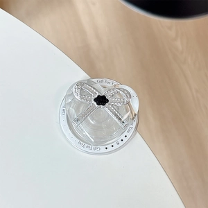 Detail of transparent heart phone grip with diamond bow and Gift For You text base