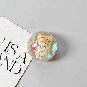Detail of a dreamy transparent phone grip featuring a cute cartoon girl inside a 3D sphere