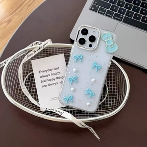 Detail of transparent iPhone case featuring 3D blue bows and pearls in a silver basket