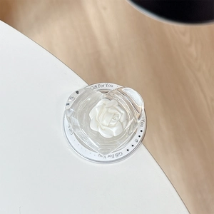 Macro view of transparent heart phone grip with 3D rose and Gift For You lettering