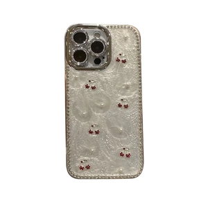 Luxurious pearl white iPhone case with rhinestone cherry patterns and diamond edges