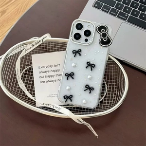 Detail of glitter iPhone case with black 3D bows, pearls and silver sequins decoration