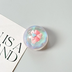 Macro detail of 3D iridescent bear heart popsocket with balloon and basket design