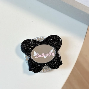 Detail of glittery butterfly phone grip with built-in mirror and rhinestone ring base