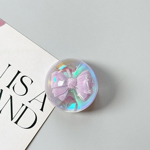 Detailed view of a holographic round phone grip with a 3D purple ribbon inside