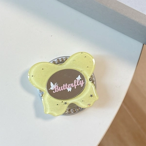 Close-up of glitter butterfly phone socket with built-in makeup mirror and crystal rim