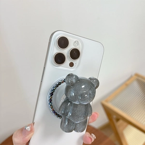 Detailed view of a glittering grey resin bear phone grip with iridescent beads