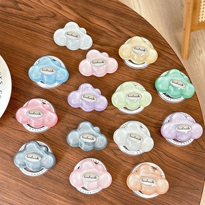 Glitter cloud phone grip set in candy colors on wooden table with handmade label