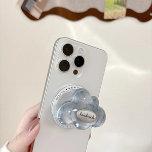 Close-up of blue glitter cloud phone socket with handmade engraving on white smartphone
