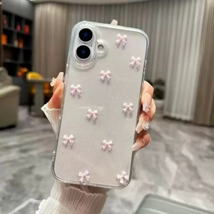 Macro detail of clear iPhone case with pink 3D bows and silver glitter texture coating