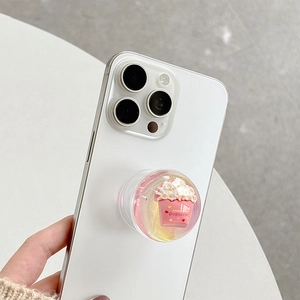 Close-up of a 3D pink popcorn miniature inside a clear resin phone socket on a white smartphone