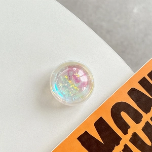 Macro shot of holographic glitter liquid quicksand phone socket with pink and yellow tones