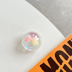 Macro shot of an iridescent crystal ball phone grip featuring pink and yellow gradients