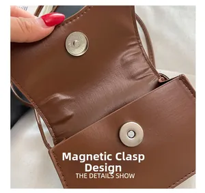 Detail of a brown leather bag showing magnetic closure and fine stitching craft
