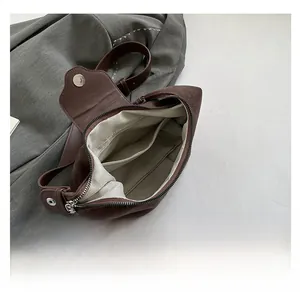 Top view of faux suede hobo bag interior showing spacious compartments and lining