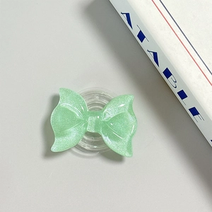 Detail view of mint green glitter bow phone grip with MagSafe magnetic suction base