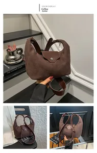 Detail view of coffee brown vintage suede shoulder bag with polished leather flap design