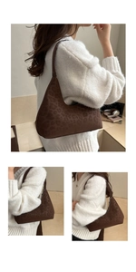 Detail view of deep brown leopard print hobo bag showing moon-shaped silhouette and texture