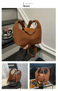 Close-up of brown suede crossbody bag with circular metal magnetic closure and detail