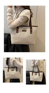 Close-up of beige canvas tote with dark brown leather handles and stitched brand logo tag
