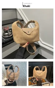 Detail of khaki faux suede dumpling bag with leather flap and silver metallic buckle