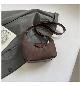 Close-up of brown vintage hobo bag showing matte suede texture and leather strap detail