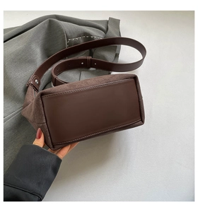 Detailed close-up of the vintage brown shoulder bag with mixed leather textures
