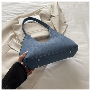 Detailed base of blue leopard print shoulder bag with silver protective metal feet