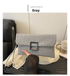 Chic grey envelope clutch bag featuring leopard print detail and a bold black square buckle