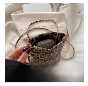 Detail view of leopard print crossbody bag with gold chain strap showing phone capacity