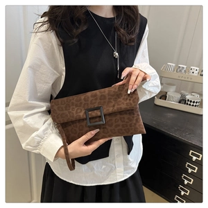 Detail of leopard print clutch bag with suede texture and black square buckle