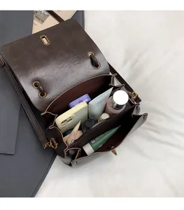 Detailed interior of the retro brown leather handbag showing compartments and storage capacity