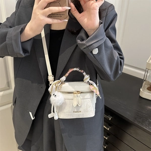 White retro faux leather handbag with scarf-wrapped handle and plush ball charm detail