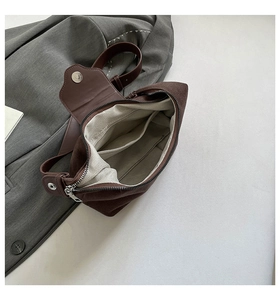 Detailed interior of dark brown crossbody bag showing herringbone lining and pockets