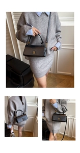 Detail of black matte leather handbag with golden metal rotating lock and handle