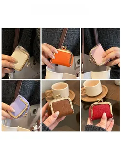 Mini kiss-lock jewelry pouches in various colors with litchi grain leather and gold clasps