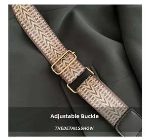 Detail of colorful geometric woven shoulder strap with adjustable golden metal buckle