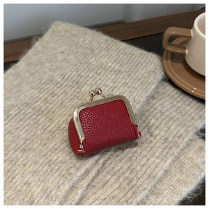 Close-up of red lychee leather mini coin purse with vintage golden metal kiss lock