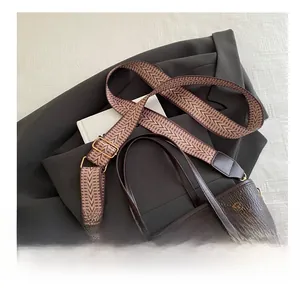 Detail of deep brown tote bag with wide vintage geometric strap and rabbit motif