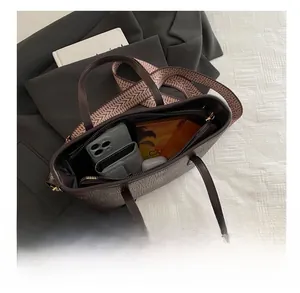 Detail view of dark brown bucket bag interior showing large capacity for daily essentials