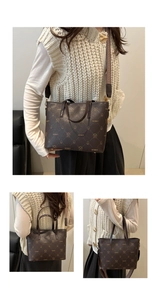 Detail of dark brown leather bucket bag with embossed bear pattern and wide textile strap