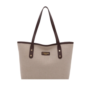 Fashion beige woven tote bag with brown leather trim and handles for daily commute