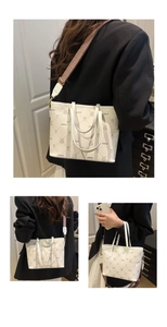 Detail of white lychee leather tote bag with rabbit print and woven shoulder strap