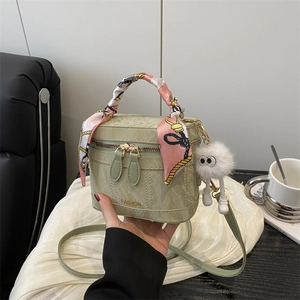 Detail of light green marble texture bag with fashion text and silk handle wrap