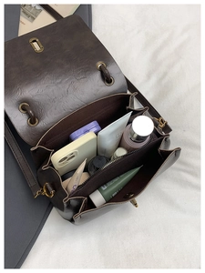 Detail view of the brown vintage bag interior showing multiple spacious compartments