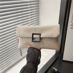 Chic cream white rectangular clutch bag with a matte black square buckle and wrist strap